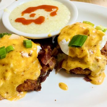 Red Rooster - Potato Cake Benedict with grits (hot sauce added) - Diners Near Me - Marco Island, Florida Red Rooster - Potato Cake Benedict with grits (hot sauce added) - Diners Near Me - Marco Island, Florida