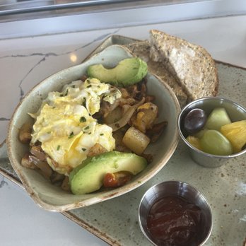 First Watch - Skillet with bacon potatoes eggs onions sun dried tomatoes cheese and avocado served with toast fruit and jam - Breakfast & Brunch Near Me - Kissimmee, Florida