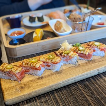 Myomi Sushi - a long piece of sushi on a cutting board - Sushi Bars Near Me - Richmond, British Columbia Myomi Sushi - a long piece of sushi on a cutting board - Sushi Bars Near Me - Richmond, British Columbia