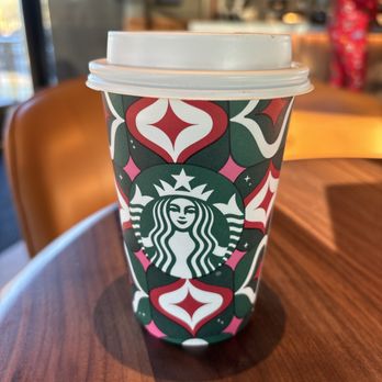 Starbucks - a starbucks cup on a table - Coffee & Tea Near Me - Manchester, Connecticut