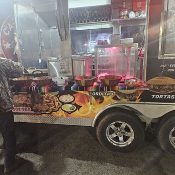 Carnitas El Viejon - a man standing in front of a food truck - Mexican Near Me - Houston, Texas