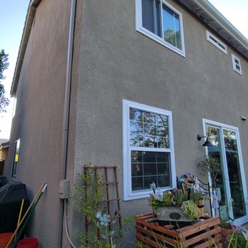 Andy's Rain Gutters - Our large downspout. We had it moved to the side and you can't even notice it from the backyard deck. The location and color are great. - Gutter Services Near Me