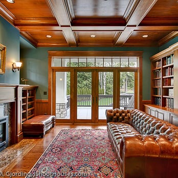 Cutuli Homes - a living room with a fireplace and bookshelves - General Contractors Near Me - Kirkland, Washington Cutuli Homes - a living room with a fireplace and bookshelves - General Contractors Near Me - Kirkland, Washington