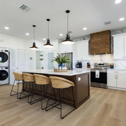 Creative Design Services - Shaker cabinets combine with a warm espresso island and hood for the perfect blend of traditional and contemporary design.