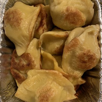 Oh Dumplings - Chicken dumplings - Dumplings with crispy, browned edges are arranged in a foil container, likely freshly cooked and ready to eat. - Chinese Near Me - Brooklyn, New York