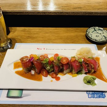 Sushi North - Dragon roll along side a Sapporo - Japanese Near Me - Westminster, Colorado Sushi North - Dragon roll along side a Sapporo - Japanese Near Me - Westminster, Colorado
