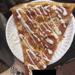 a slice of pizza on a paper plate a slice of pizza on a paper plate