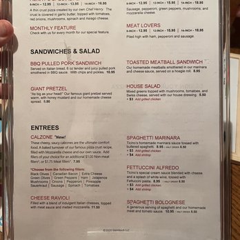 Ticino Pizzeria - a hand holding a menu - Pizza Near Me - New Glarus, Wisconsin