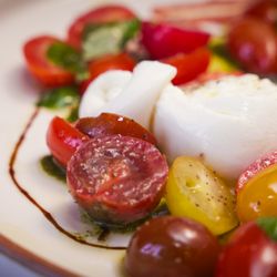 Osteria Tavi - Heirloom tomatoes burrata, cheese, hazelnut romesco, sage vinaigrette served with focaccia