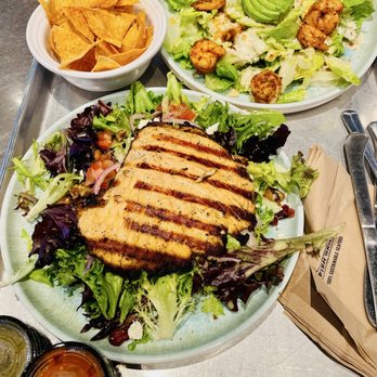 California Fish Grill - Salad with grilled salmon/Cesar salad with shrimps/chips and salsa - Seafood Near Me - El Cerrito, California California Fish Grill - Salad with grilled salmon/Cesar salad with shrimps/chips and salsa - Seafood Near Me - El Cerrito, California