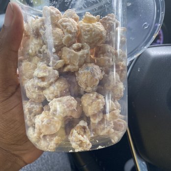 Poppin' Stop - hand holding a bag of popcorn - Popcorn Shops Near Me - Conyers, Georgia Poppin' Stop - hand holding a bag of popcorn - Popcorn Shops Near Me - Conyers, Georgia