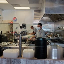 two men working in a commercial kitchen two men working in a commercial kitchen