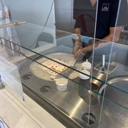 Gentleman did a smiley face of Carmel before rolling the ice cream. So cute