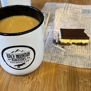 Black Mountain Roasters - a cup of coffee and a piece of cake - Coffee Roasteries Near Me - Drumheller, Alberta