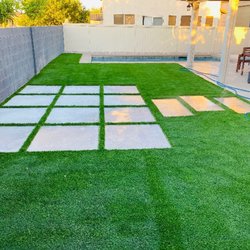 AAA Landscaping - Beautiful backyard with Artificial Turf and large flat steppingstones.
