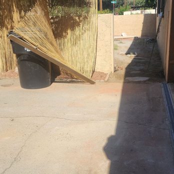 Tony's Landscape - Pipe goes along the area where you see red pebbles  along the bamboo fencing. Garage drain looks great! - Landscaping Near Me - Rialto, California