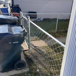 John removed the old gate and fence, and set the new one further back so I now I have a place to set my city garage bins