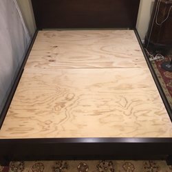 Custom cut plywood placed on my platform bed