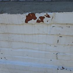 5 Star Chimney Service - Deteriorating Drylok visibly separating from the brick face, exposing compromised masonry underneath