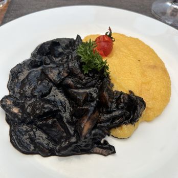 Bakarò - Cuttlefish and polenta (the cuttlefish is ink is very very overwhelmingly seafoody) - Venetian Near Me - Venezia, VE Bakarò - Cuttlefish and polenta (the cuttlefish is ink is very very overwhelmingly seafoody) - Venetian Near Me - Venezia, VE