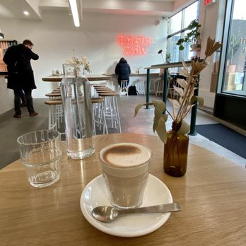 Bright Side - a cup of cappuccino on a wooden table - Cafes Near Me - Brooklyn, New York