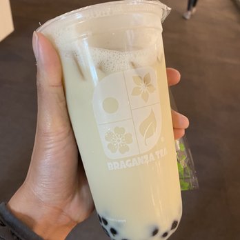 Braganza Tea - a hand holding a glass of milk tea - Bubble Tea Near Me - Portland, Oregon Braganza Tea - a hand holding a glass of milk tea - Bubble Tea Near Me - Portland, Oregon