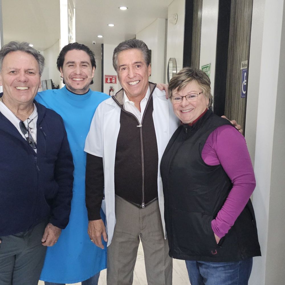 Father and son dentists - Dr De La Vega - happy smiles all round and lots of new teeth!
