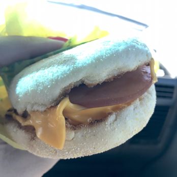 McDonald's - a hand holding a hot dog - Burgers Near Me - Madisonville, Texas