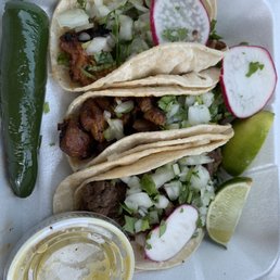 Two tacos de al pastor and one taco de asada Two tacos de al pastor and one taco de asada