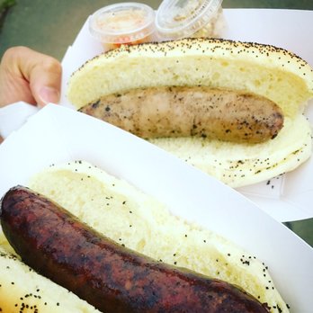 Smoking Goose - Turkey beer dawg and veal dog hot off the grill with Fermenti artisan kraut and Local folks food stone ground mustard - Meat Shops Near Me - Indianapolis, Indiana