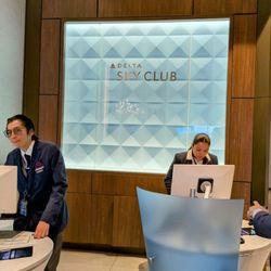 LAX Terminal 3 - Two staff helping customers at the DELTA SKY CLUB