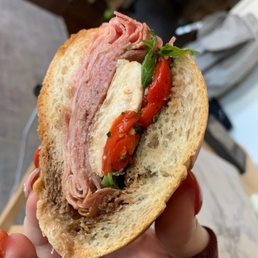 a person holding a sandwich