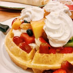 Cora Breakfast & Lunch - Waffle with fruits and whipped cream on top