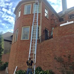 A & A Wildlife and Home Solutions - A&A Team using the 60' ladder to reach openings and seal out critters from home in Alpharetta.