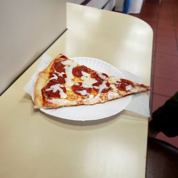 Napoli Pizza - a slice of pepperoni pizza on a paper plate - Pizza Near Me - Brooklyn, New York
