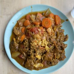 A Taste of Bim - Fish Stew served with mild island curry sauce with peppers, tomatoes, and onions