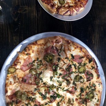 Milano's Pizza - BBQ chicken pizza with jalapeños & a pink sauce, Canadian bacon, spinach & jalapeño pizza! ( pink sauce is a mix of alfredo & marinara) - Chicken Wings Near Me - Bowie, Texas