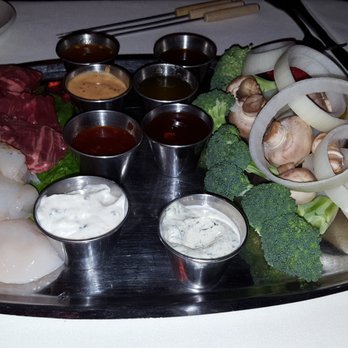 Geja's Cafe - Each dinner is given 4 fondue forks to cook their dinner according to their taste. - Fondue Near Me - Chicago, Illinois