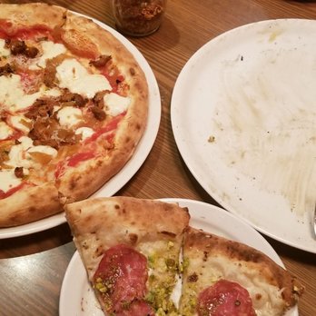 Fat Olives - Spicey meat pizza (left) Pistachio pizza (right) - Pizza Near Me - Flagstaff, Arizona