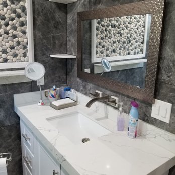 Prestigio Custom Tile - Master vanity in quartz slab, 24x24 porcelain tiles around the walls, frame picture on the wall with pebbles tiles. - Tiling Near Me - Van Nuys, California Prestigio Custom Tile - Master vanity in quartz slab, 24x24 porcelain tiles around the walls, frame picture on the wall with pebbles tiles. - Tiling Near Me - Van Nuys, California