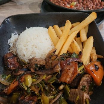 Cilantro Latin Fusion - Lomo Saltado. Flank steak w/ onion and tomato and cilantro in a wine reduction sauce that was so delicious. Perfect white rice and fries. - Venezuelan Near Me - Columbus, Ohio