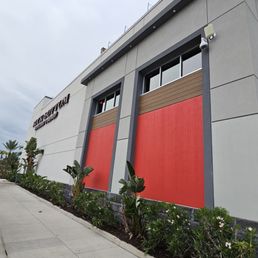 the side of a building with a red and gray exterior the side of a building with a red and gray exterior