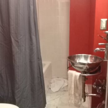 Hotel Max - Little bathroom, notice the tiny sink with only a small glass shelf for counter space. - Hotels Near Me - Seattle, Washington