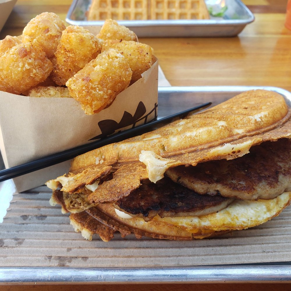 Bruxie - My order country sausage and eggs on a waffle with a side of spiced tots. - Sandwiches Near Me - Orange, California