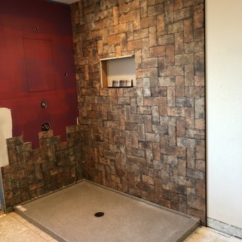 Condon Contracting - Setting each piece of tile with spacers before adding grout. The new shower replaced the master bathroom tub. - General Contractors Near Me - Parker, Colorado