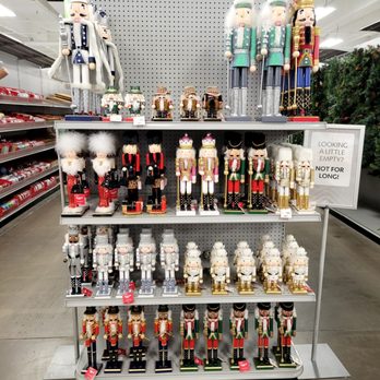 At Home - Nutcrackers.  I dunno, but they sure say Christmas time to me. - A store display features various nutcracker figurines arranged on shelves, all priced under $45, with a sign indicating holiday decor. - Home Decor Near Me - Albuquerque, New Mexico