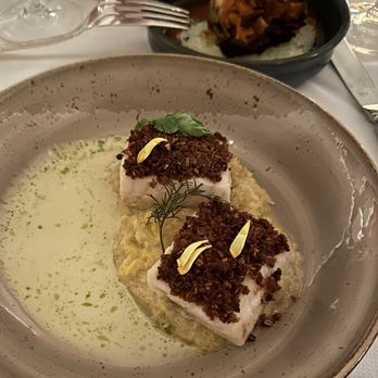 Georgie - BUTTER POACHED STURGEON Chicken Skin Crumble, Preserved Cabbage. Smoked Buttermilk Nage w/Roasted Maitake Mushroom - New American Near Me - Dallas, Texas