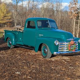 an old truck parked in a field