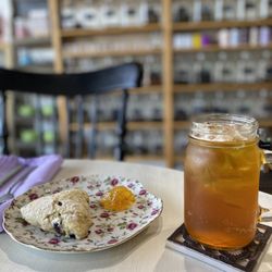 Aunt Jenn's Tea & Spice Shop - Iced Black Currant black tea with artisan blueberry scone and orange marmalade.