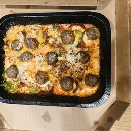 Crust less pizza with sausage, meatballs, old world pepperoni and green peppers.